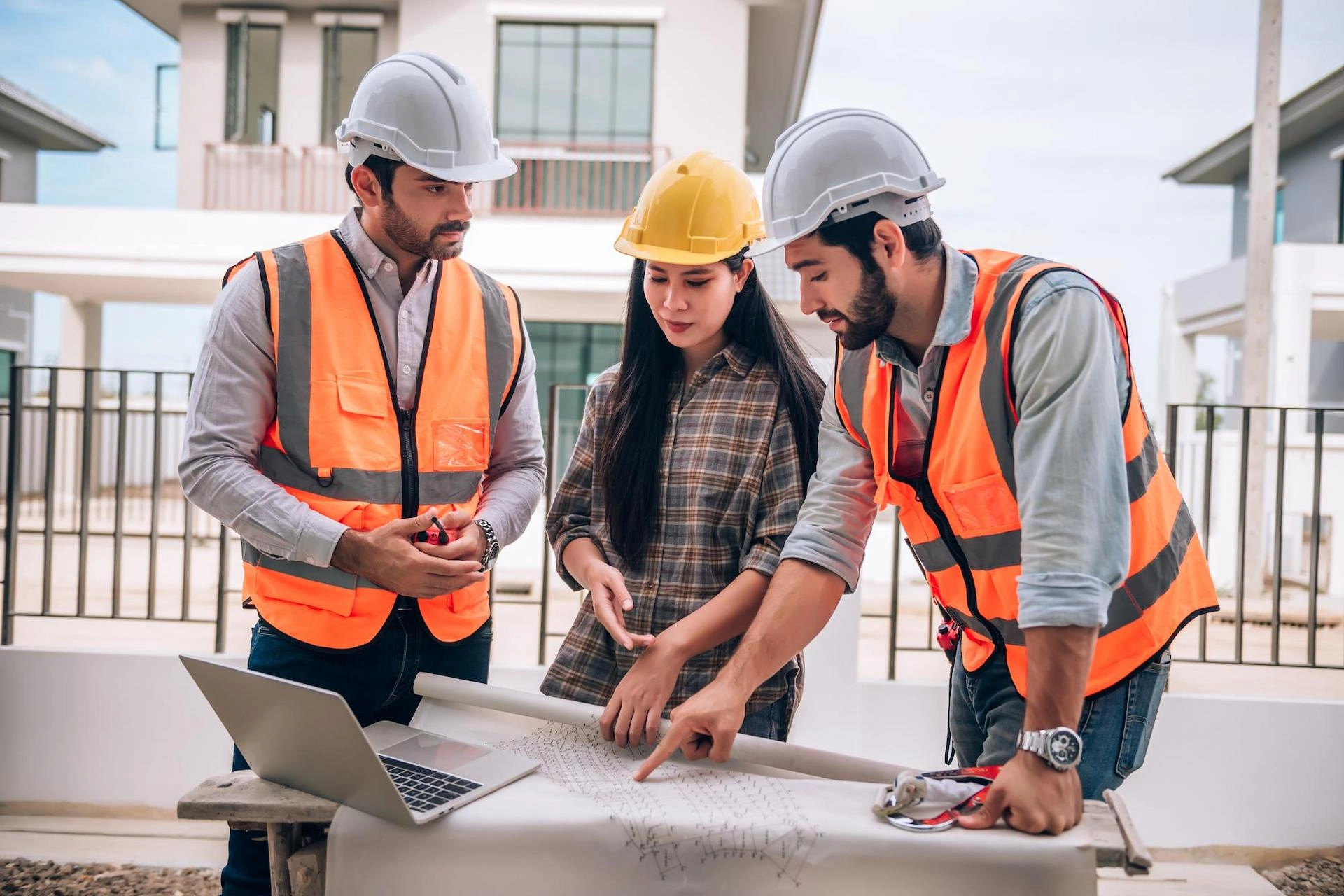 Construction Team Reviewing Blueprints
